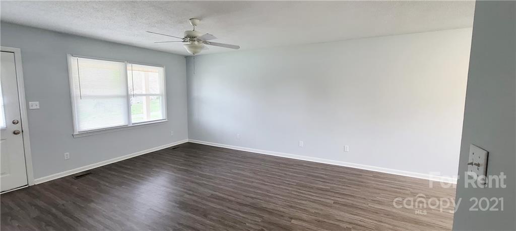 3560 Boggs Road Claremont, NC 28610 - Photo 6 of 15 a view of an empty room with wooden floor and a window