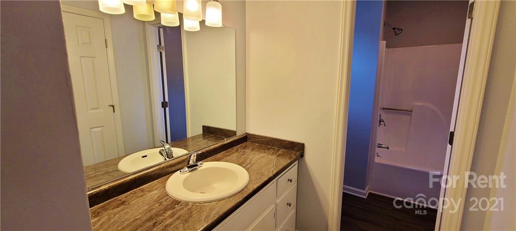 3560 Boggs Road Claremont, NC 28610 - Photo 10 of 15 a bathroom with a granite countertop sink and a mirror