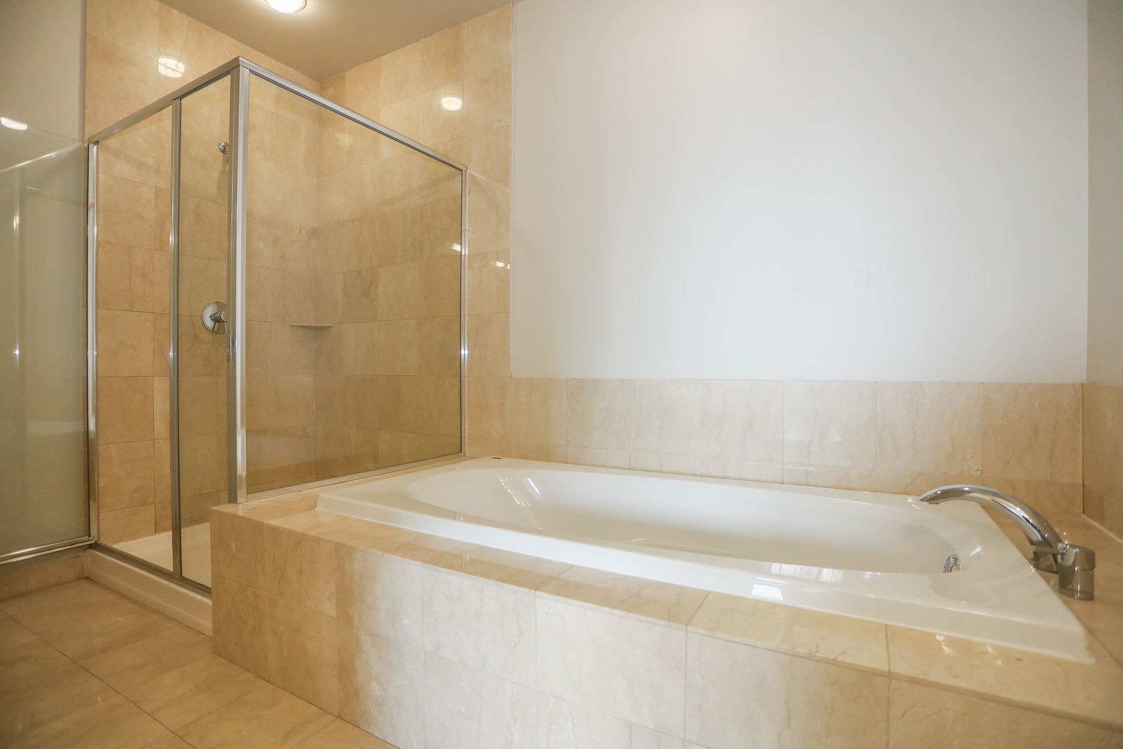 910 West Huron Street, Unit 1310 Chicago, IL 60642 - Photo 13 of 25 a spacious bathroom with a bathtub and shower