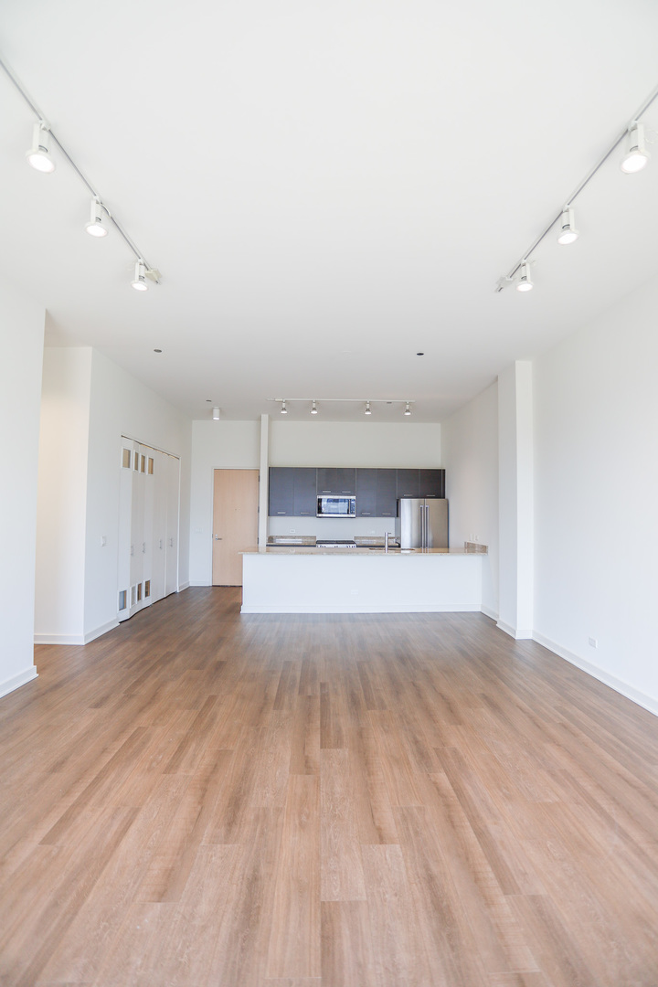 910 West Huron Street, Unit 1310 Chicago, IL 60642 - Photo 8 of 25 a view of empty room with wooden floor