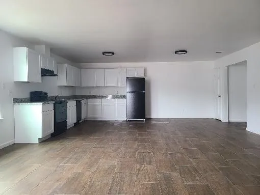 a kitchen with stainless steel appliances granite countertop a refrigerator and a stove