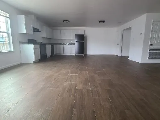 a view of a kitchen with a sink and a window