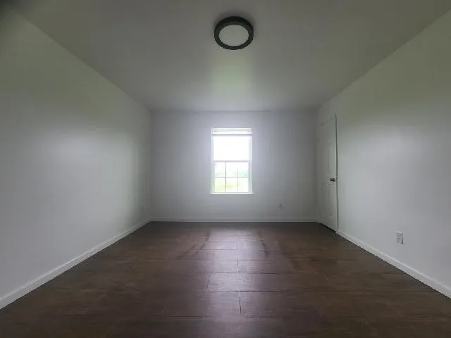 an empty room with a empty space and windows