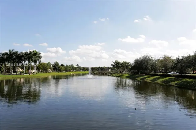 a view of a lake with houses in the back