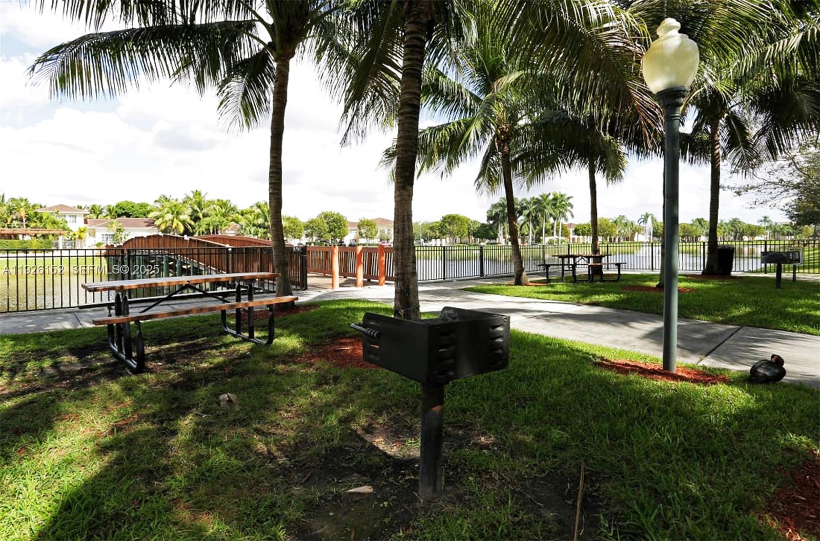 2451 Centergate Drive, Unit 104 Miramar, FL 33025 - Photo 4 of 6 a garden with palm trees