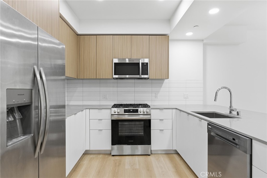 12078 Guerin Street, Unit 101 Studio City, CA 91604 - Photo 3 of 10 a kitchen with a sink a stove and refrigerator