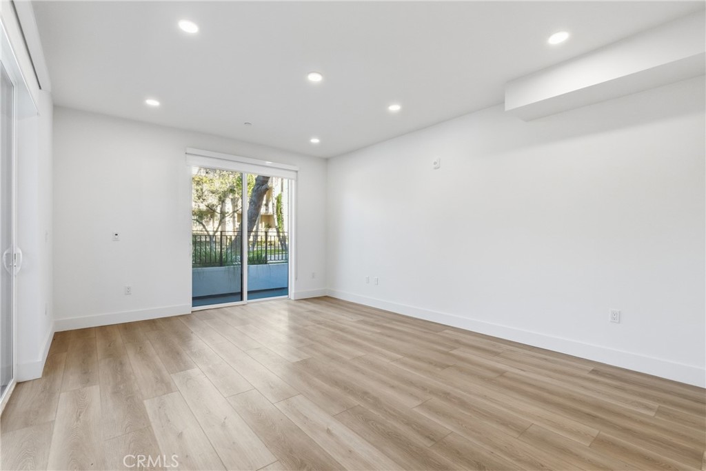 12078 Guerin Street, Unit 101 Studio City, CA 91604 - Photo 5 of 10 a view of an empty room with wooden floor and a window