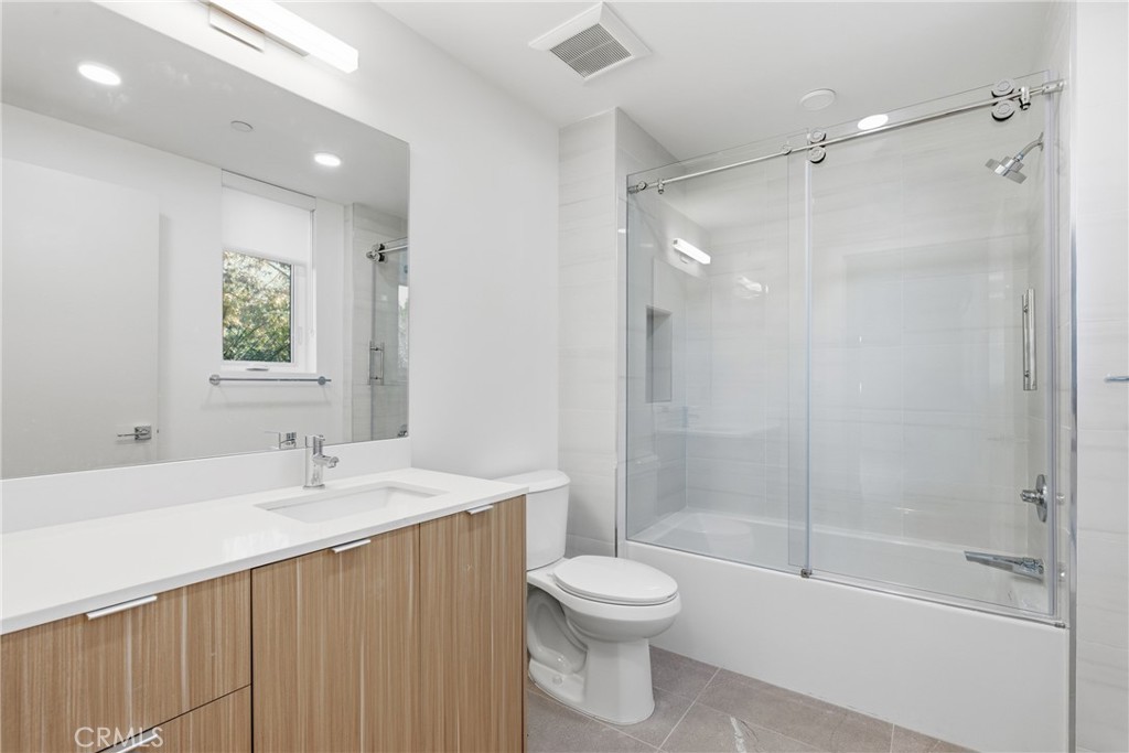 12078 Guerin Street, Unit 101 Studio City, CA 91604 - Photo 7 of 10 a bathroom with a sink a toilet and shower