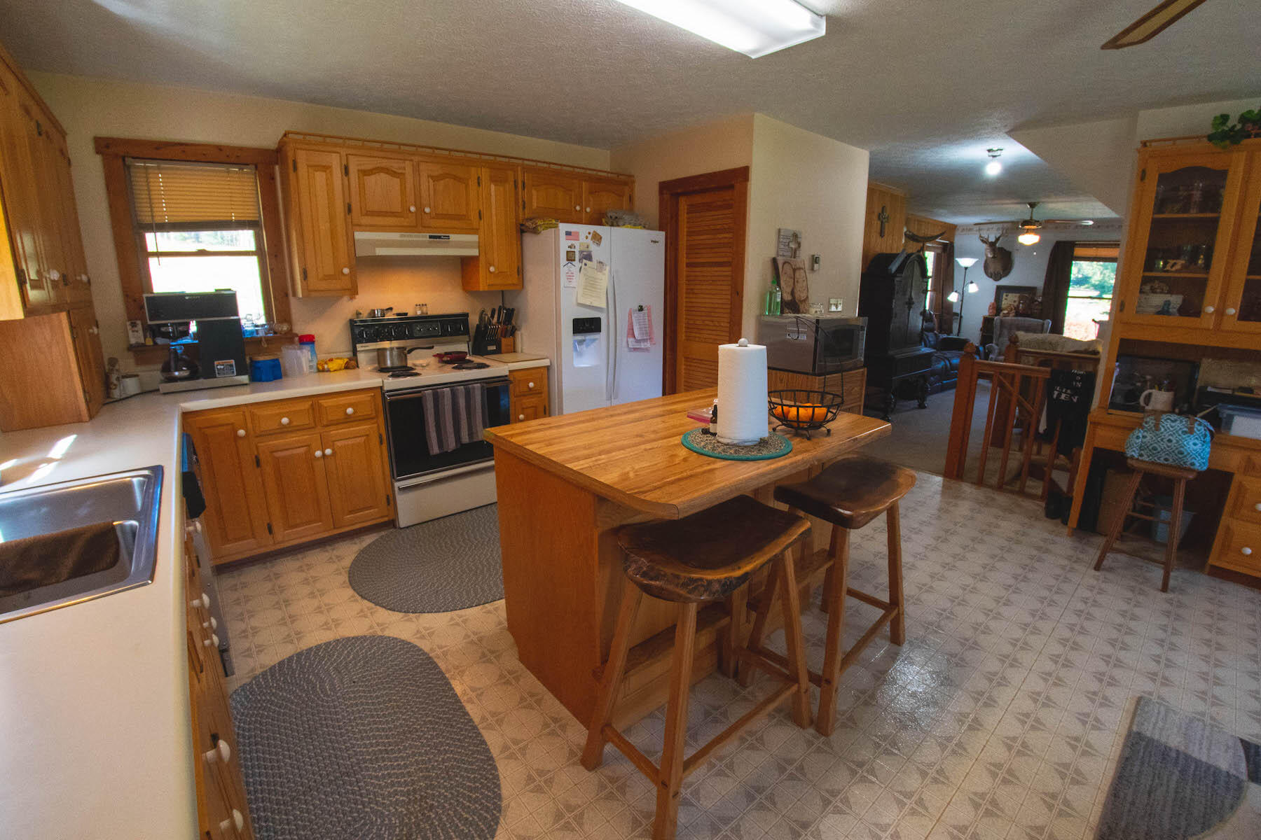 13945 Callaway Road Callaway, VA 24067 - Photo 6 of 32 a open kitchen with stainless steel appliances kitchen island granite countertop a sink a stove a dining table and chairs