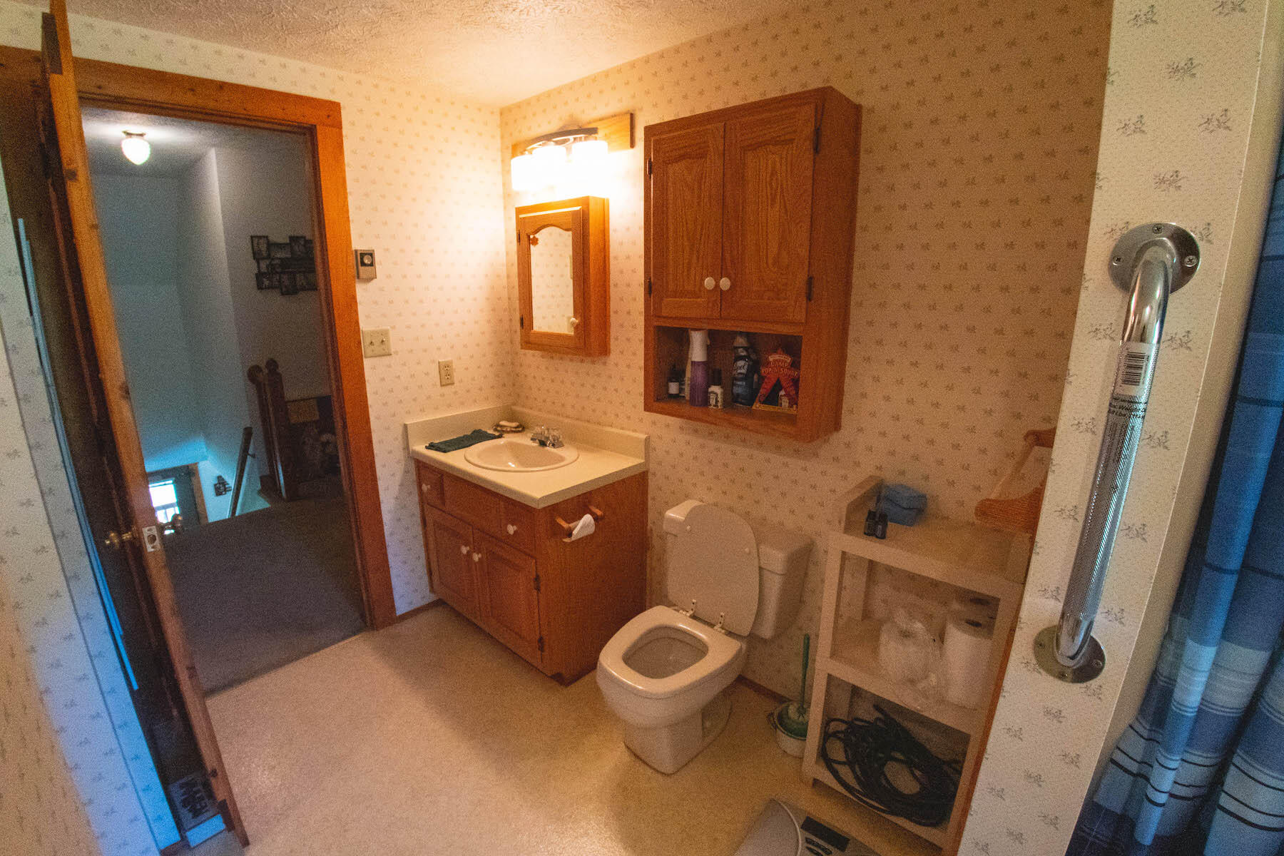 13945 Callaway Road Callaway, VA 24067 - Photo 10 of 32 a bathroom with a granite countertop toilet sink and mirror