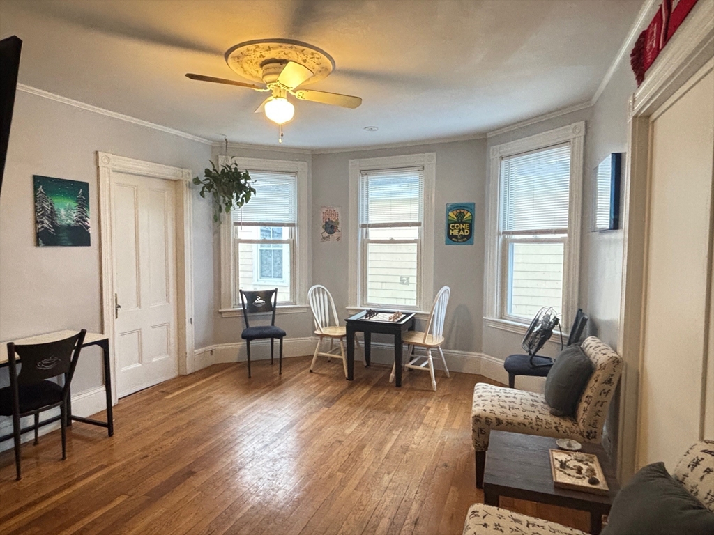 a living room with furniture dining table and a window
