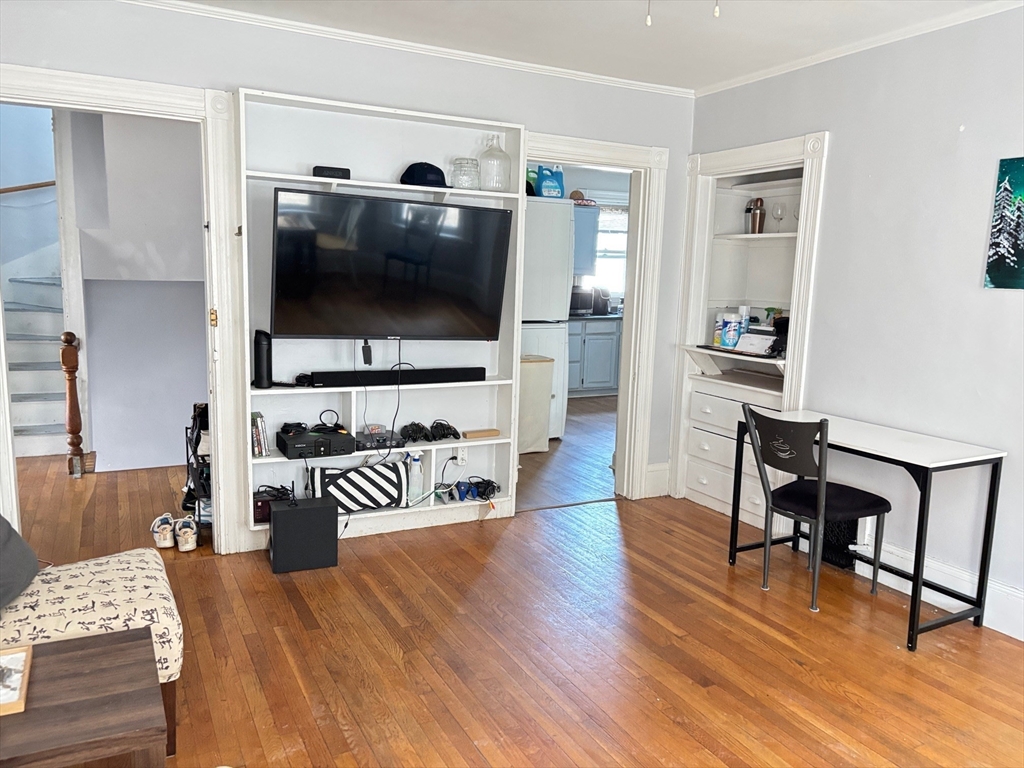 6 Bayard Street Boston, MA 02134 - Photo 2 of 15 a bedroom with furniture and a flat screen tv