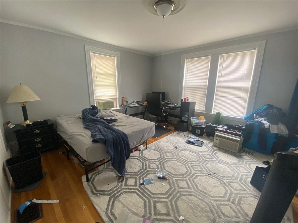 6 Bayard Street Boston, MA 02134 - Photo 7 of 15 a bedroom with a bed a lamp and a large window