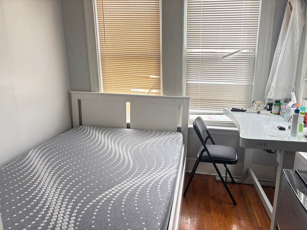 6 Bayard Street Boston, MA 02134 - Photo 8 of 15 a bedroom with a bed a table and chair