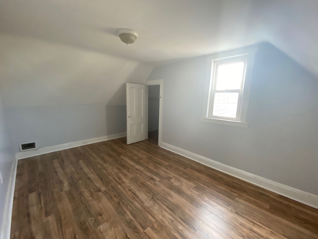 6 Bayard Street Boston, MA 02134 - Photo 9 of 15 wooden floor in an empty room with a window