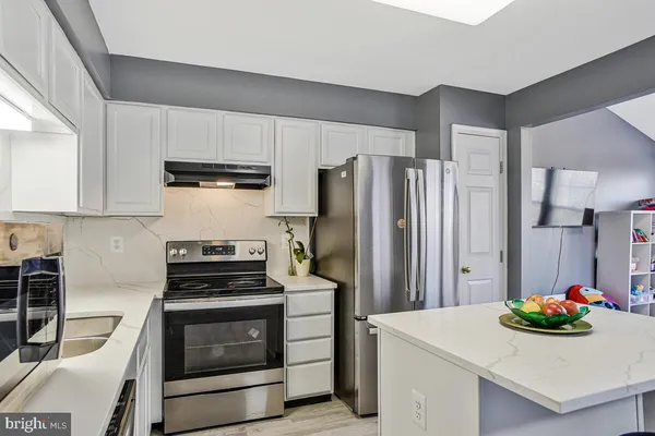 a kitchen with a sink stove and refrigerator