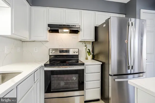 a kitchen with stainless steel appliances a refrigerator stove and microwave
