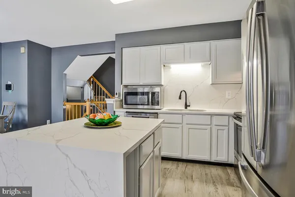 a kitchen with sink cabinets and stainless steel appliances