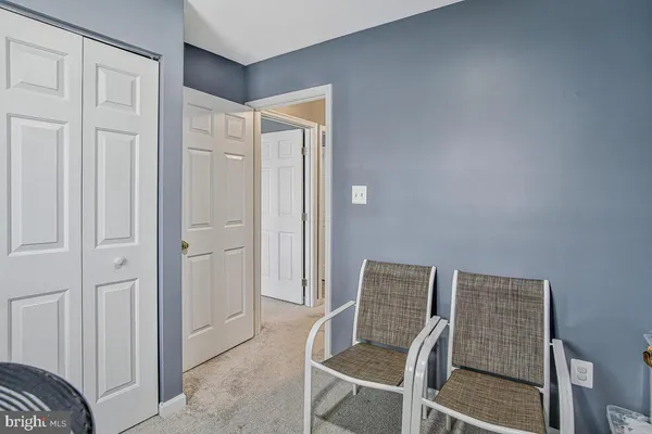 a view of a hallway with furniture and closet