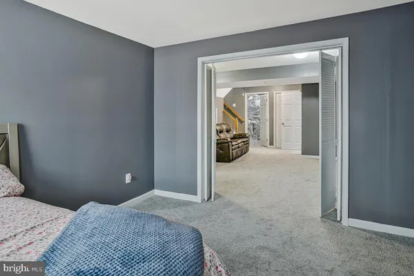 a bedroom with a bed and a mirror