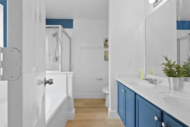 a bathroom with a sink and mirror with toilet