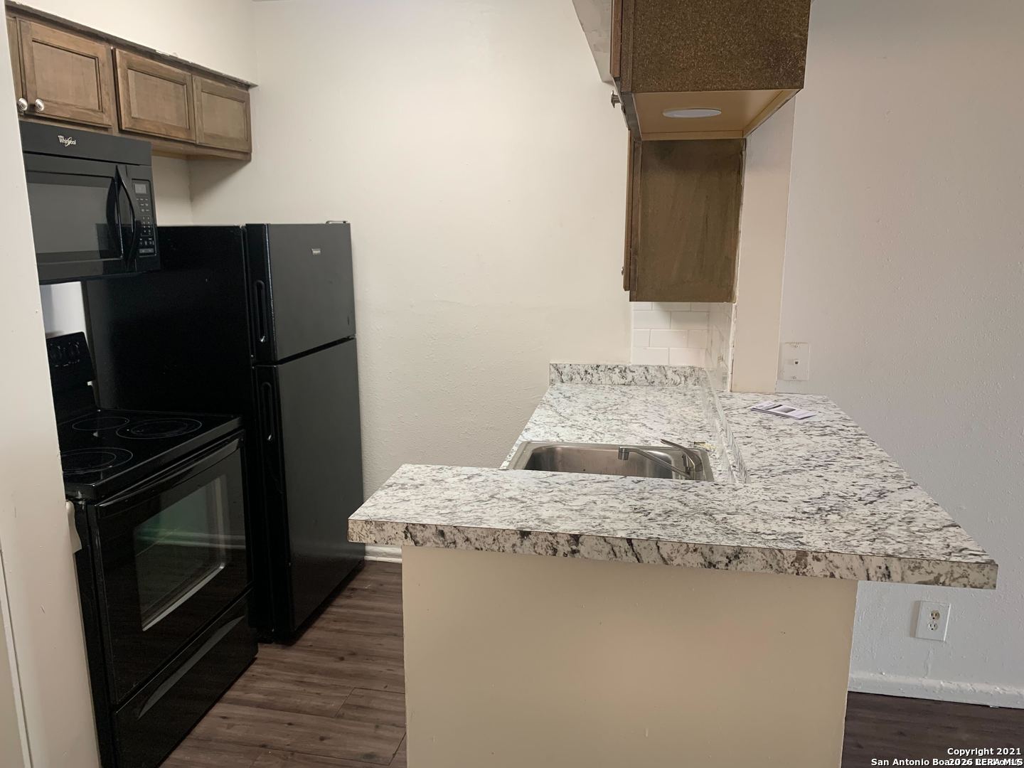 170 De Chantle Road, Unit 503 San Antonio, TX 78201 - Photo 5 of 12 a kitchen with a sink and a refrigerator