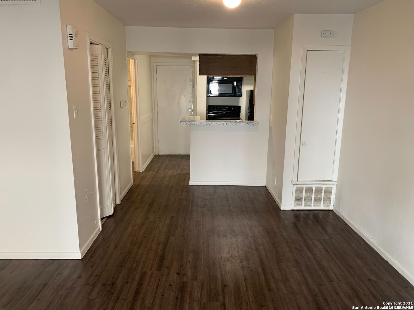 170 De Chantle Road, Unit 503 San Antonio, TX 78201 - Photo 7 of 12 a view of a hallway with wooden floor and a cabinet