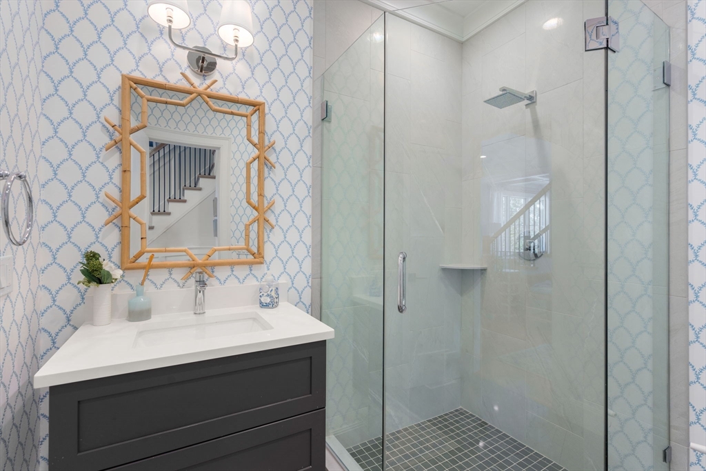 33 Maugus Hill Road Wellesley, MA 02481 - Photo 15 of 34 a bathroom with a sink a mirror and shower