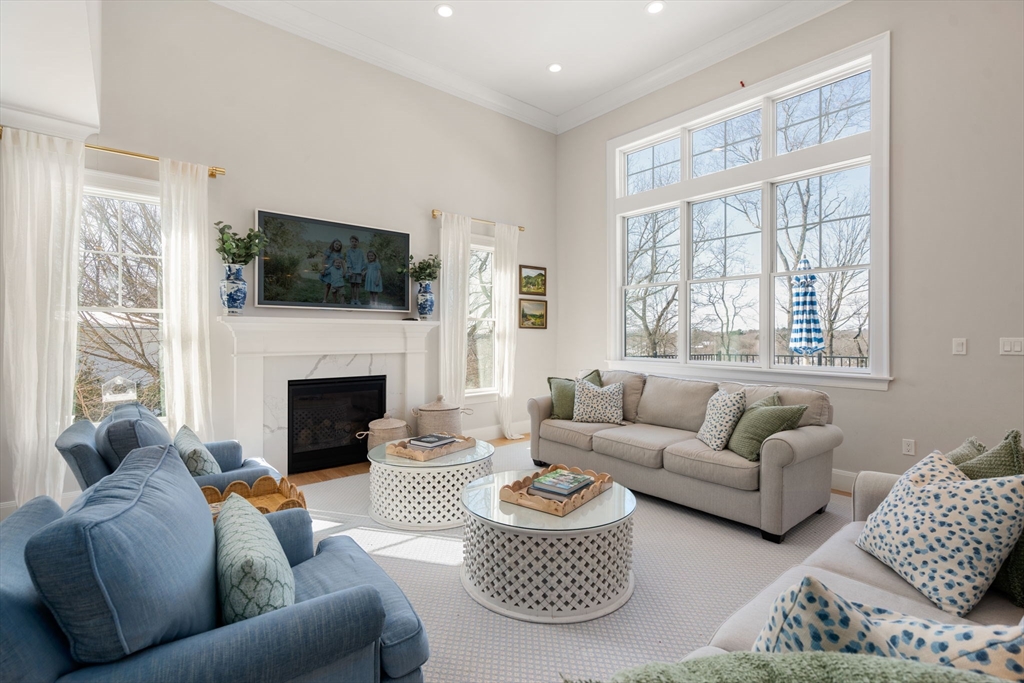 33 Maugus Hill Road Wellesley, MA 02481 - Photo 4 of 34 a living room with furniture a flat screen tv and a fireplace