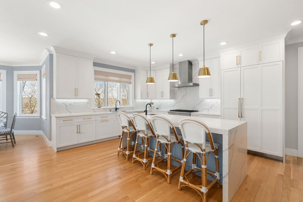 33 Maugus Hill Road Wellesley, MA 02481 - Photo 5 of 34 a large white kitchen with lots of counter space a sink appliances and a large window
