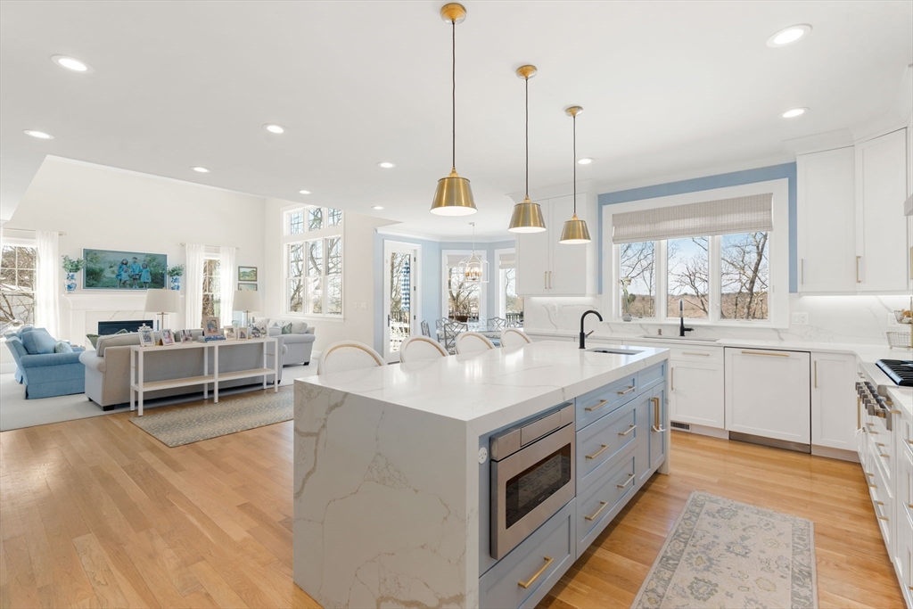 33 Maugus Hill Road Wellesley, MA 02481 - Photo 7 of 34 a kitchen with kitchen island a large counter top space a sink stainless steel appliances and windows