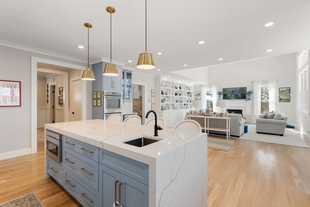 33 Maugus Hill Road Wellesley, MA 02481 - Photo 8 of 34 a large kitchen with kitchen island a stove a sink a island and chairs