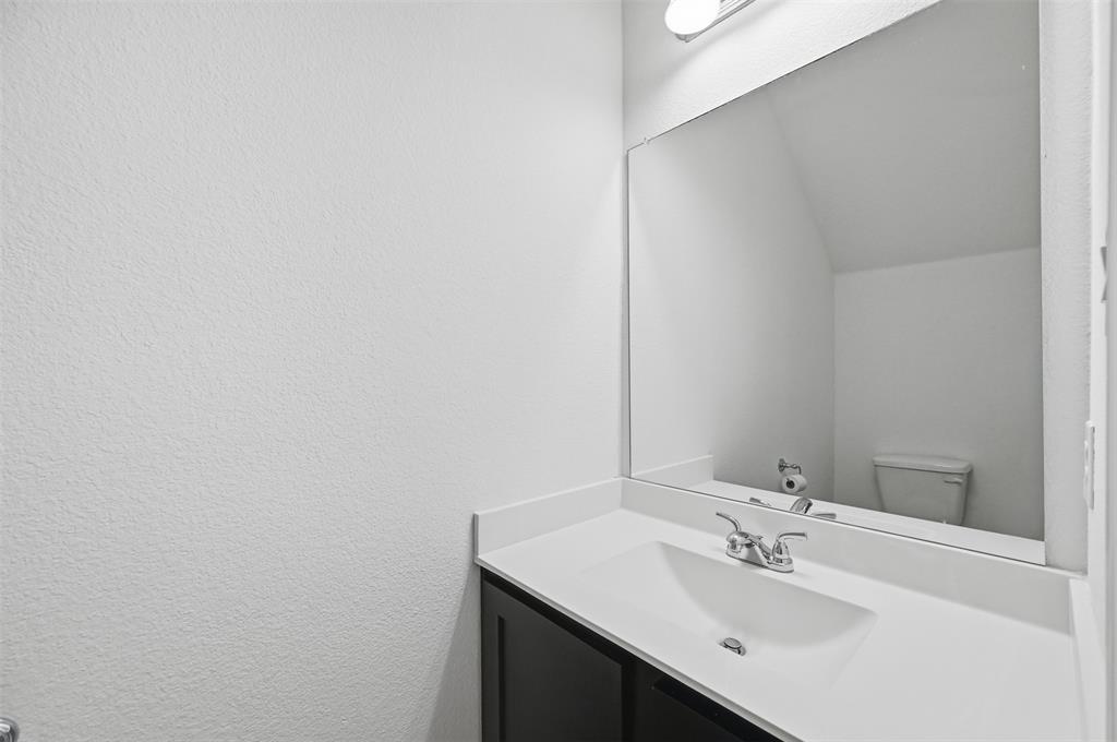 400 Wrangler Lane, Unit 400 Denton, TX 76209 - Photo 11 of 18 a bathroom with a sink and a mirror
