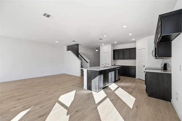 a kitchen with stainless steel appliances kitchen island sink refrigerator and stove