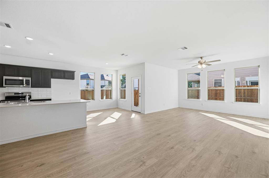 400 Wrangler Lane, Unit 400 Denton, TX 76209 - Photo 4 of 18 a view of kitchen with stainless steel appliances refrigerator oven and stove