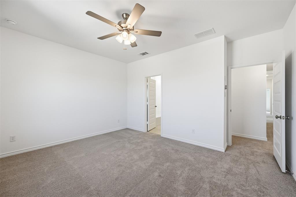 400 Wrangler Lane, Unit 400 Denton, TX 76209 - Photo 7 of 18 an empty room with a fan & a window