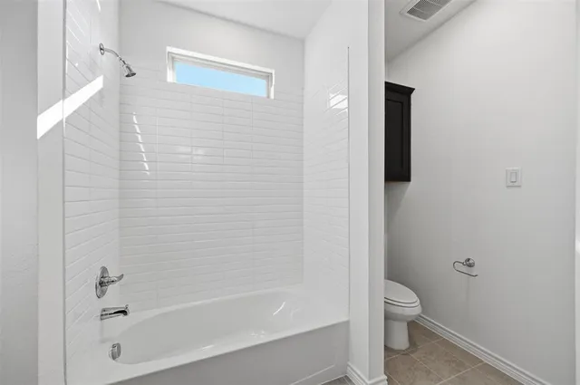a bathroom with a toilet and a bathtub