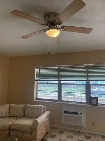 a view of a house with a big yard and potted plants