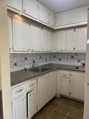 a kitchen with stainless steel appliances granite countertop a sink and cabinets