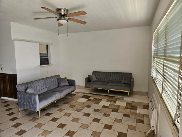 a living room with a couch and a rug