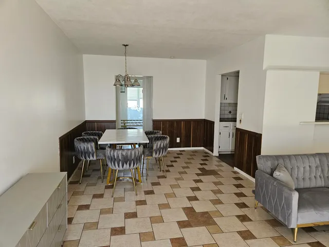 a dining room with table chairs and entryway