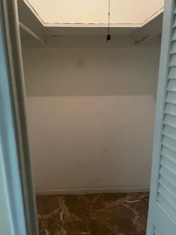a bathroom with a granite countertop toilet sink and mirror