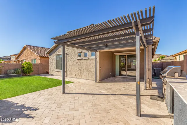 a view of a chair and table in backyard of the house