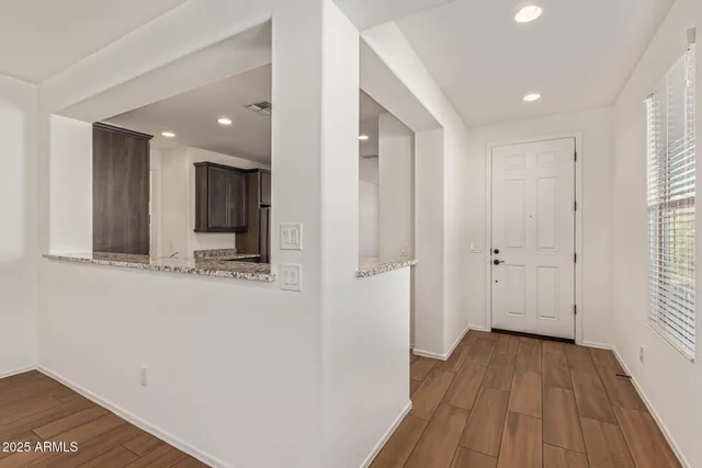 a kitchen with stainless steel appliances granite countertop a refrigerator and a stove top oven