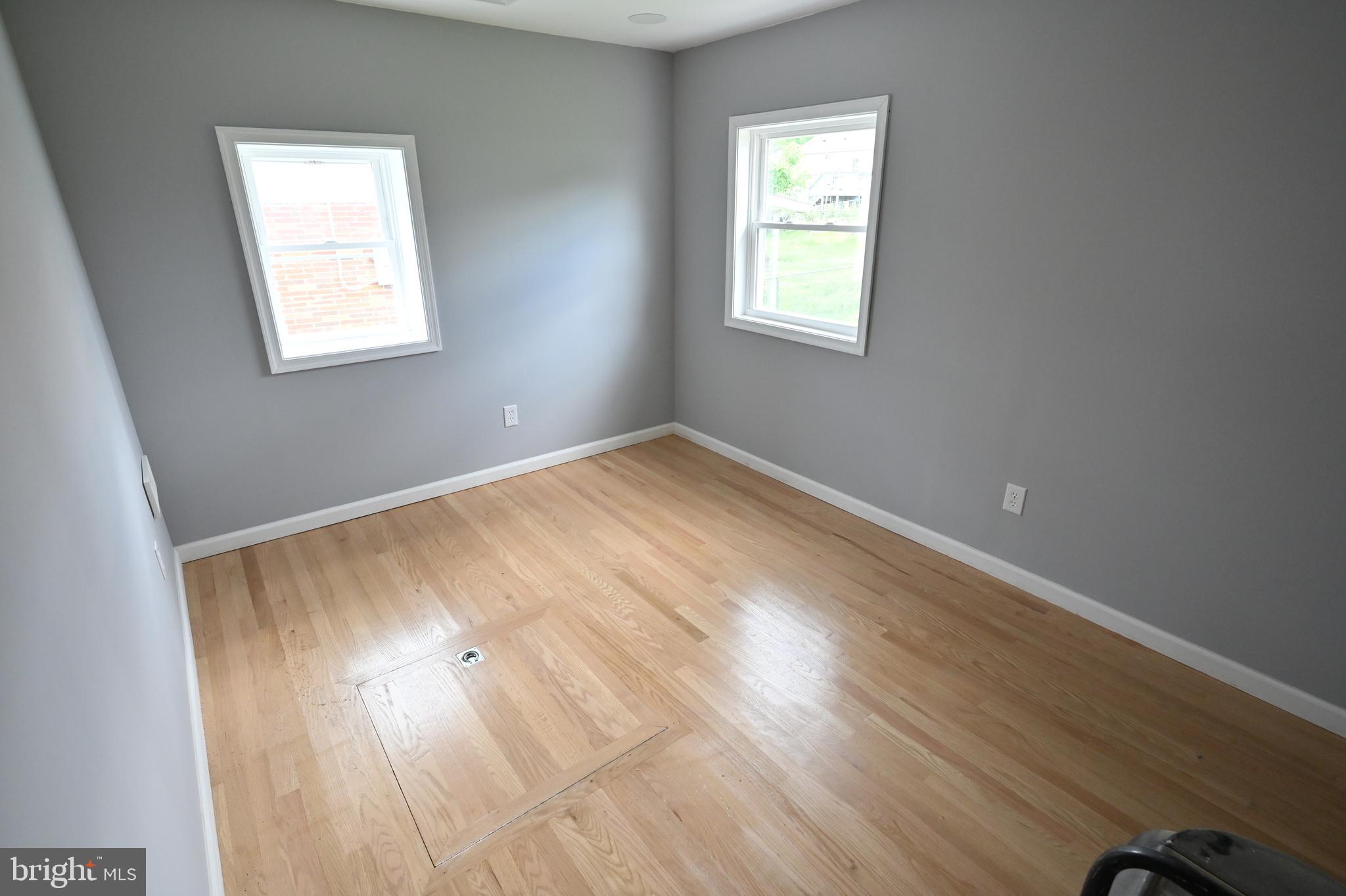 34 Compass Road East Middle River, MD 21220 - Photo 12 of 25 an empty room with wooden floor and windows
