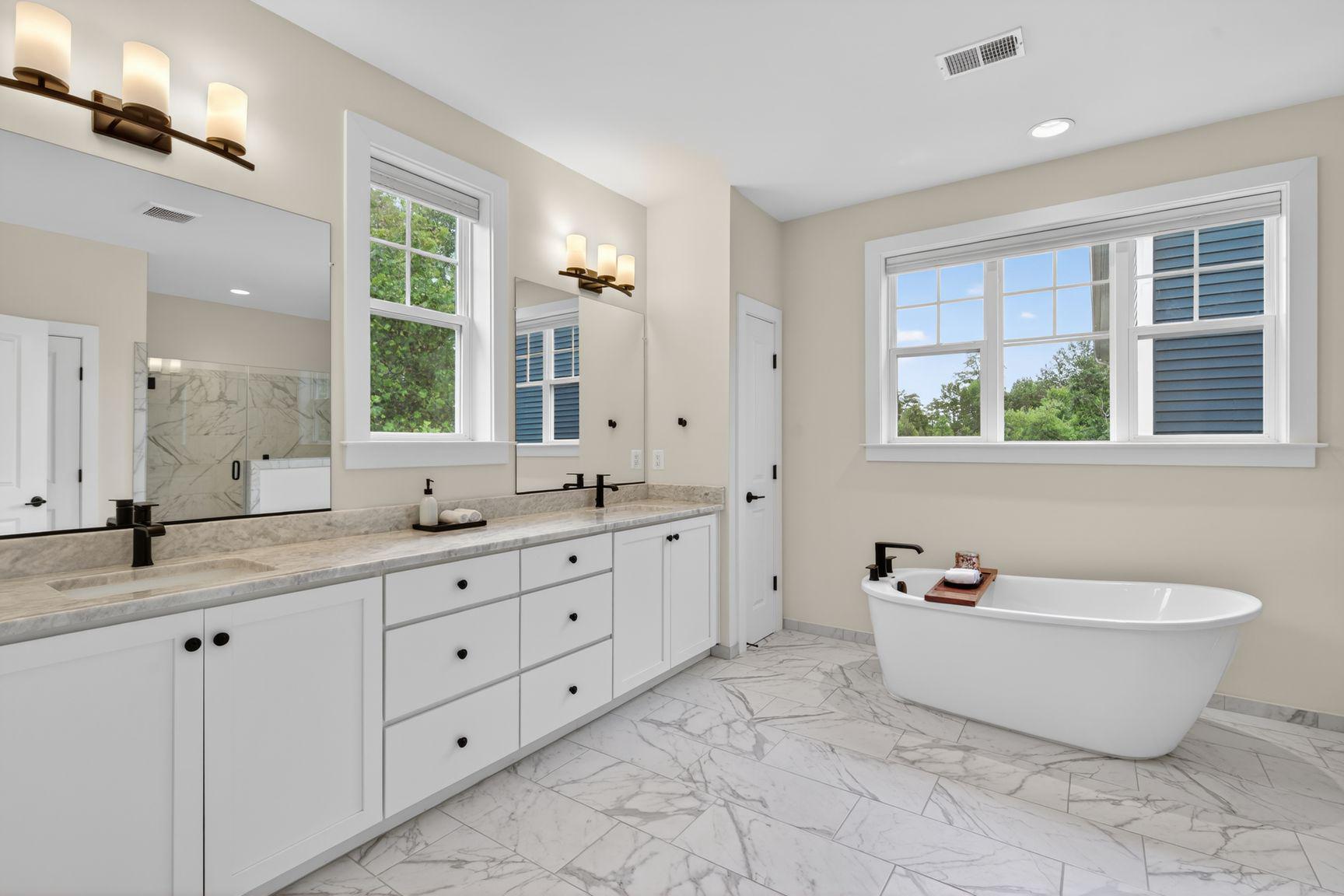 6213 Mcconnell Lane Springfield, VA 22152 - Photo 20 of 39 a spacious bathroom with a granite countertop tub a double vanity sink a window and a mirror