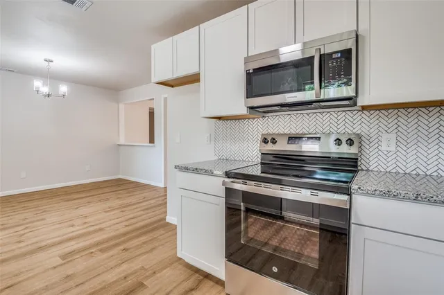 a kitchen with stainless steel appliances granite countertop a sink and a granite counter tops