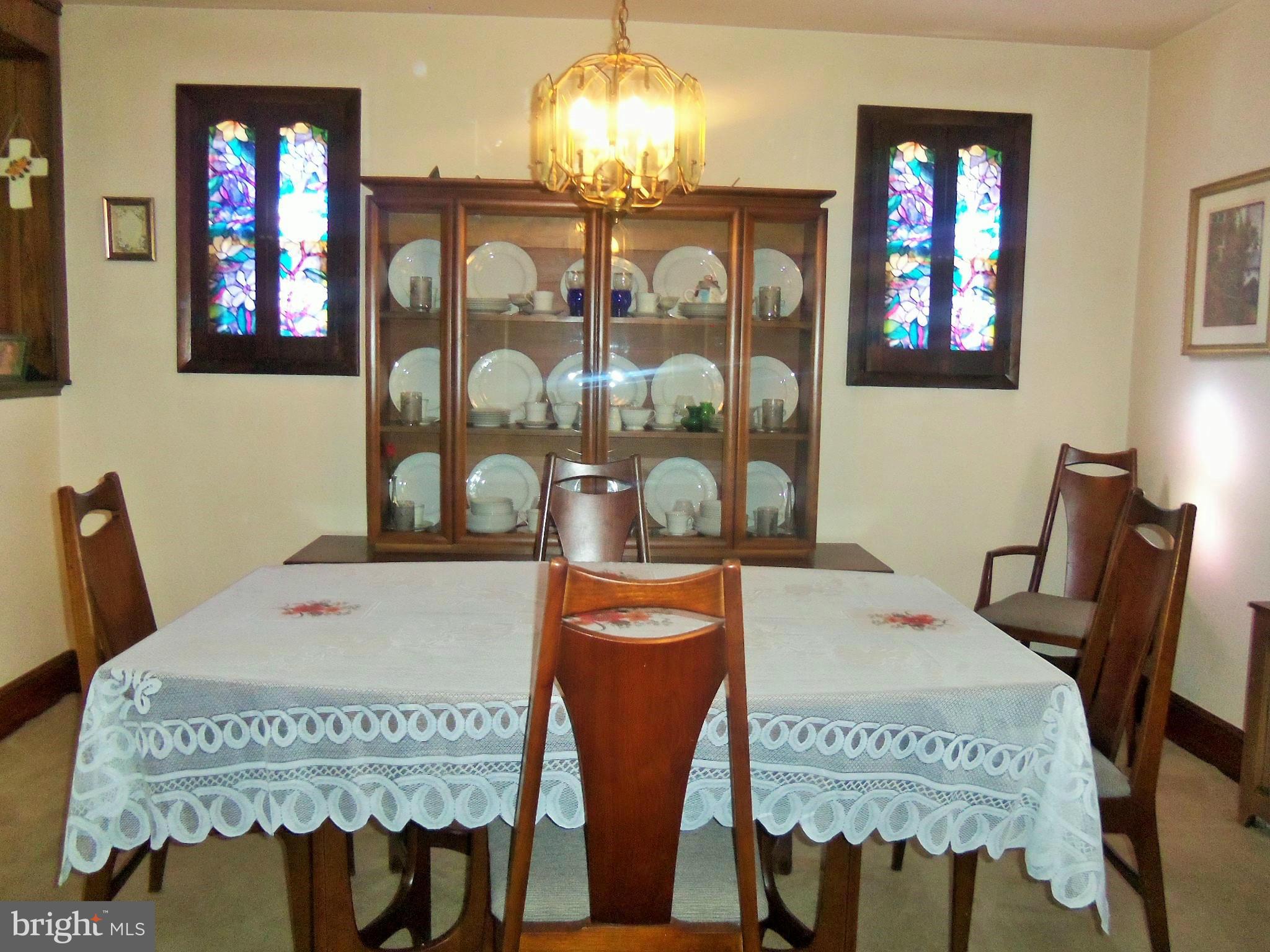 5574 Ashbourne Road Baltimore, MD 21227 - Photo 11 of 29 a view of a dining room with furniture and chandelier