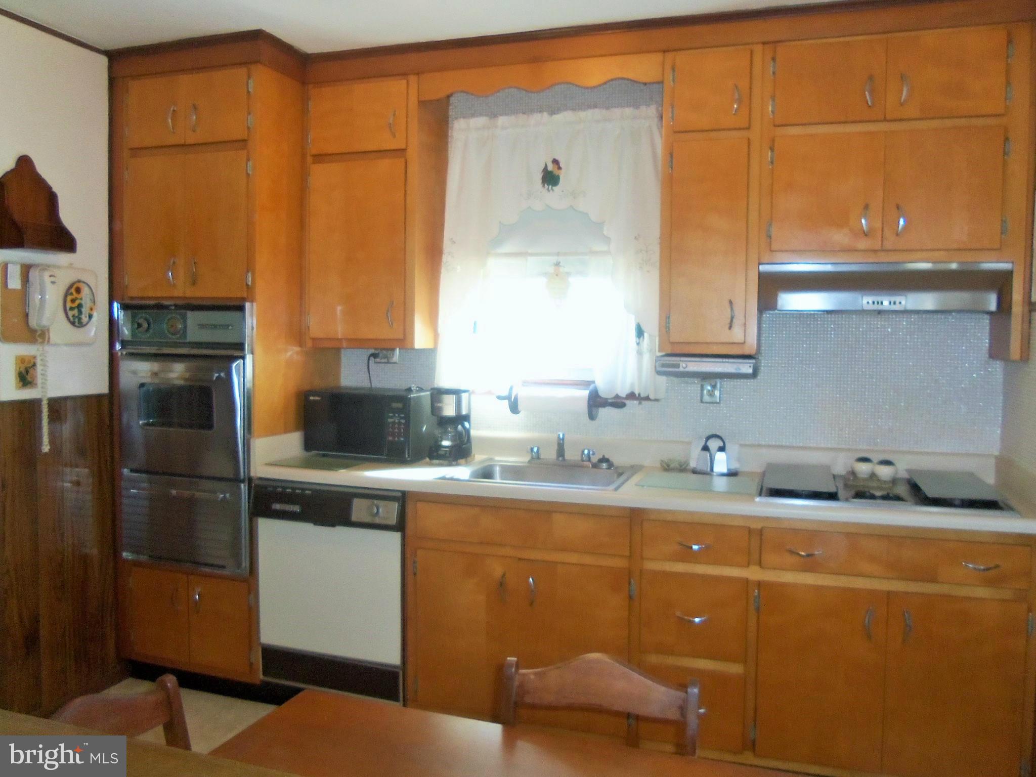 5574 Ashbourne Road Baltimore, MD 21227 - Photo 14 of 29 a kitchen with stainless steel appliances granite countertop a sink and cabinets