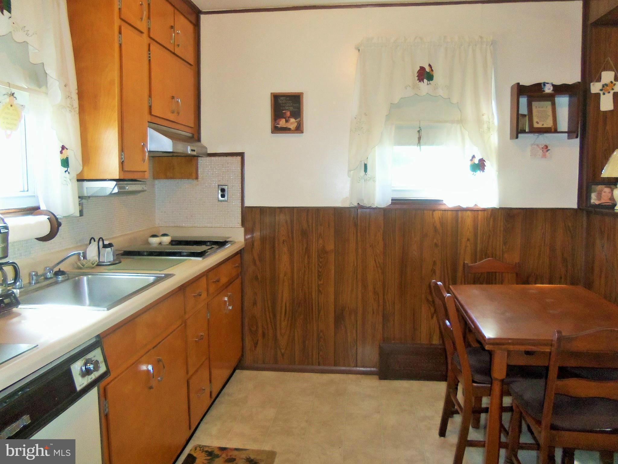 5574 Ashbourne Road Baltimore, MD 21227 - Photo 15 of 29 a kitchen with a sink cabinets and window